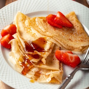Thin sourdough crêpes finished with fresh strawberries and maple syrup.
