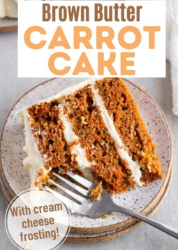 Fork cutting into a soft slice of brown butter carrot cake. Text overlay reads with cream cheese frosting.