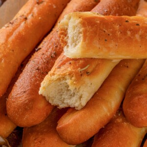 Herbed garlic breadsticks seasoned with oregano and garlic butter.