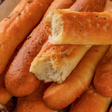 Herbed garlic breadsticks seasoned with oregano and garlic butter.