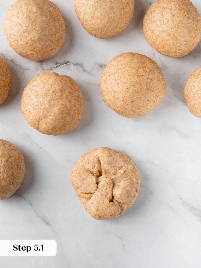 Dough being folded inward to create structure before shaping into round rolls.