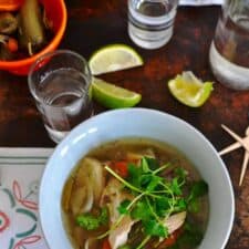 This slow cooker caldo de pollo is a delicious chicken soup recipe that comes together in 15 minutes, flavored with chiles, cilantro, mint, and marjoram. Slow Cooker Mexican Chicken soup recipe. Latin recipes, healthy Latin recipe, Mexican recipe, Mexican chicken soup clado de pollo. #caldodepollo #mexicanchickensoup #healthyMexicanrecipe #healthysouprecipe