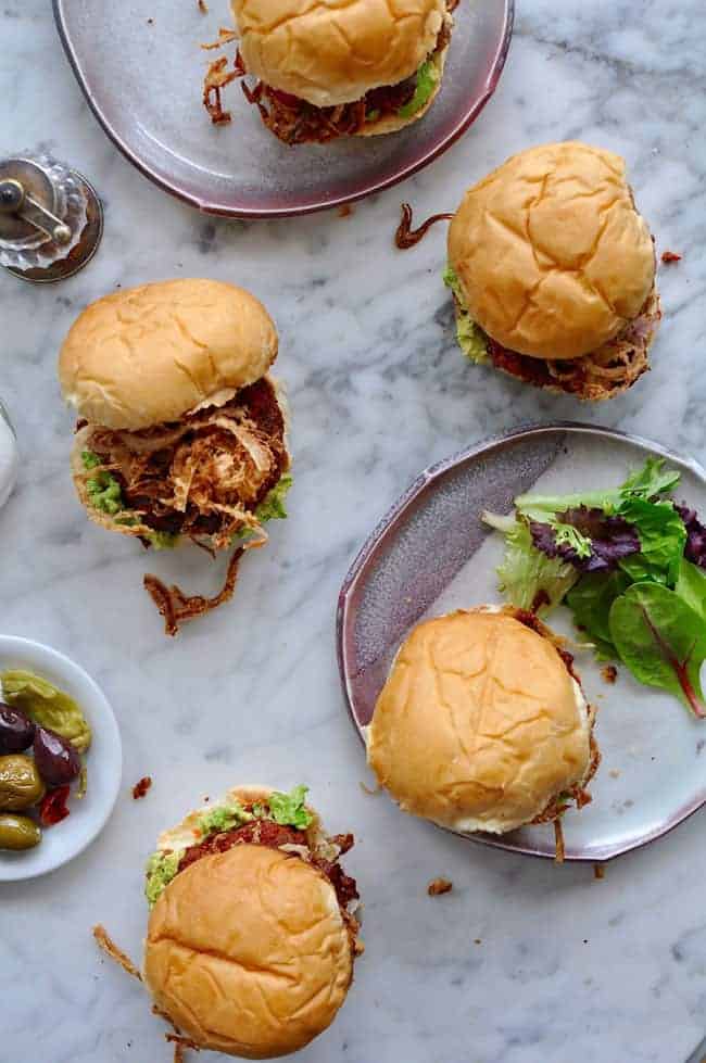 These chorizo burgers are made with Mexican chorizo and ground beef then topped with smashed avocado and a generous pile of crispy fried red onion strings.