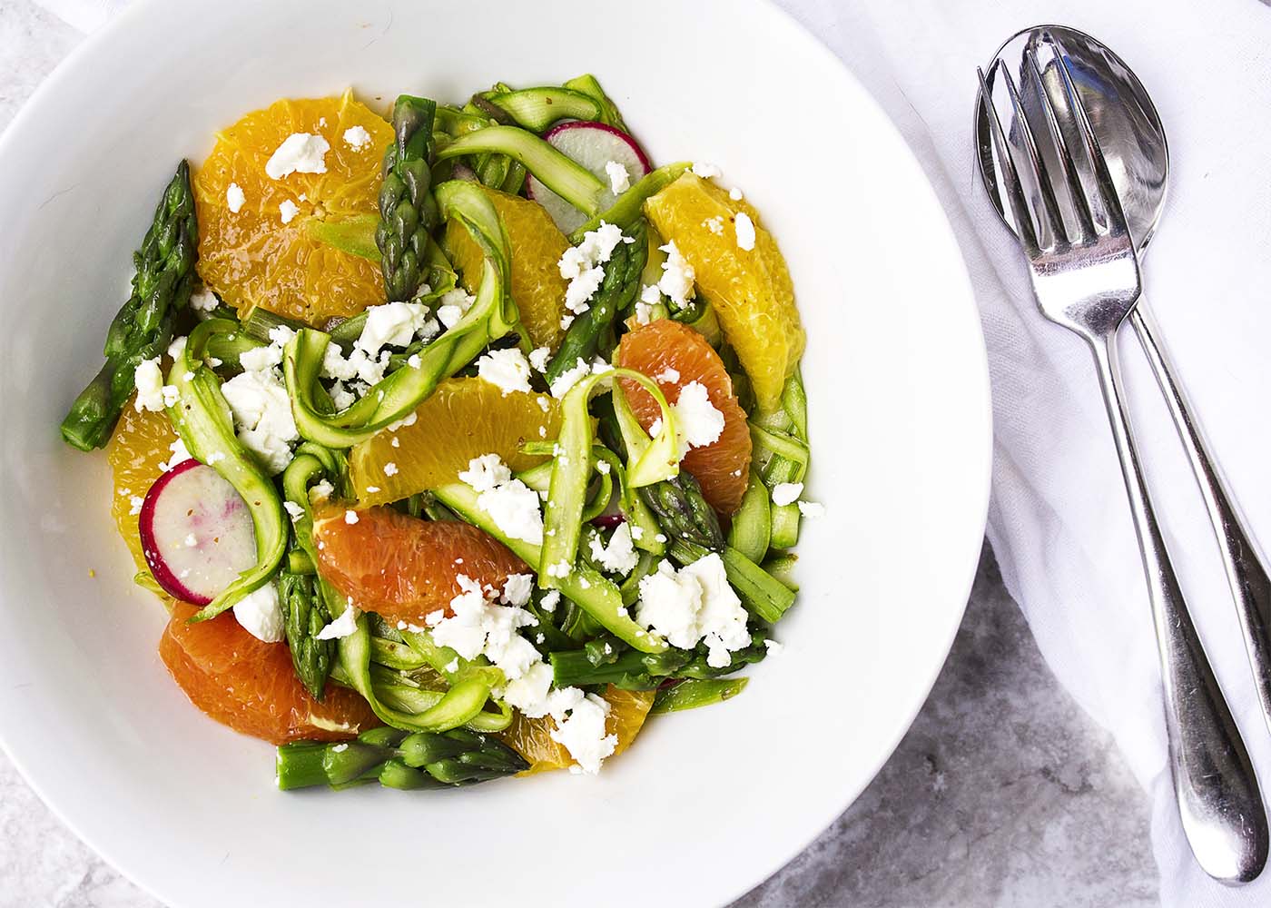 Shaved Asparagus and Orange Salad - Looking for something a little different to do with asparagus? Bored with your usual salad routine? Shaved asparagus salad is great and fun way to use asparagus with sweet oranges and spicy radishes all tossed with an orange vinaigrette. | justalittlebitofbacon.com