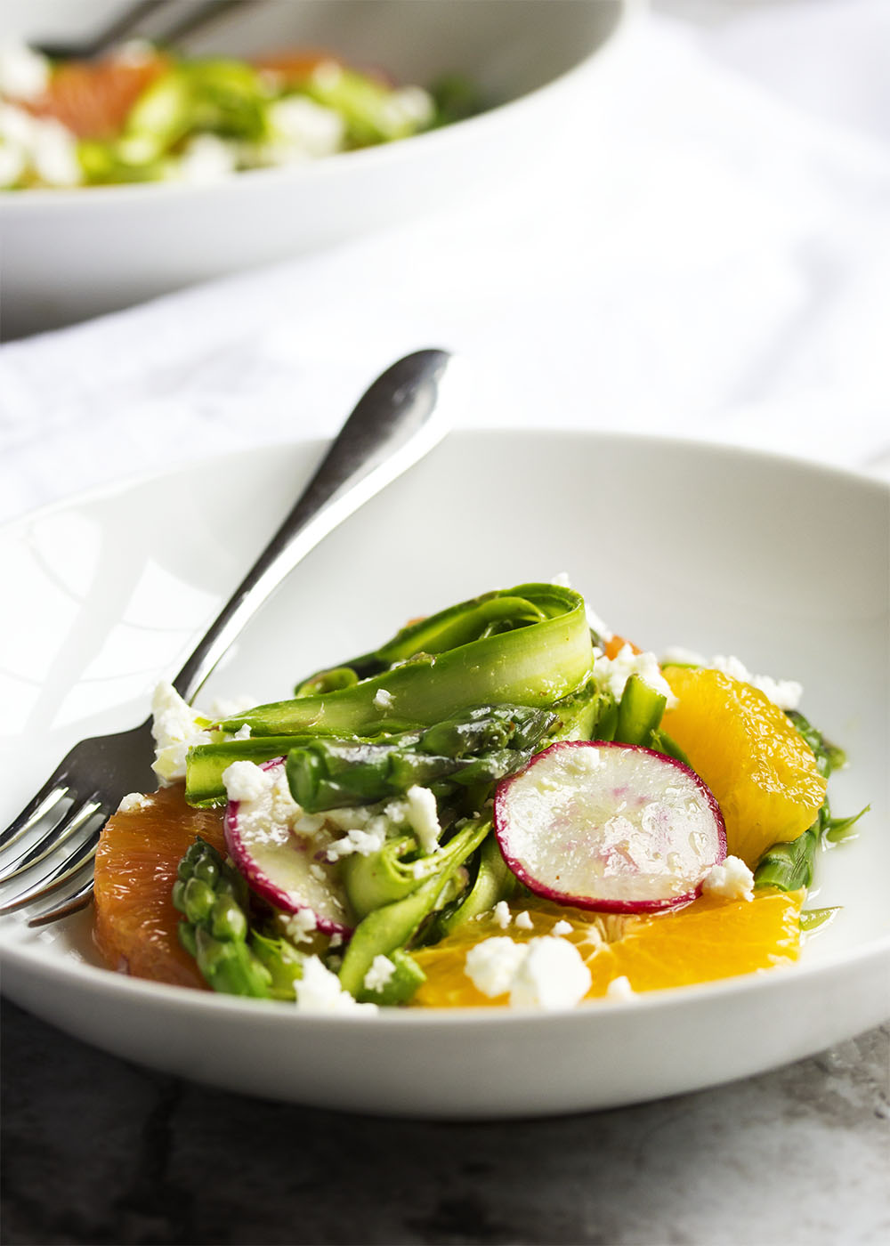 Shaved Asparagus and Orange Salad - Looking for something a little different to do with asparagus? Bored with your usual salad routine? Shaved asparagus salad is great and fun way to use asparagus with sweet oranges and spicy radishes all tossed with an orange vinaigrette. | justalittlebitofbacon.com