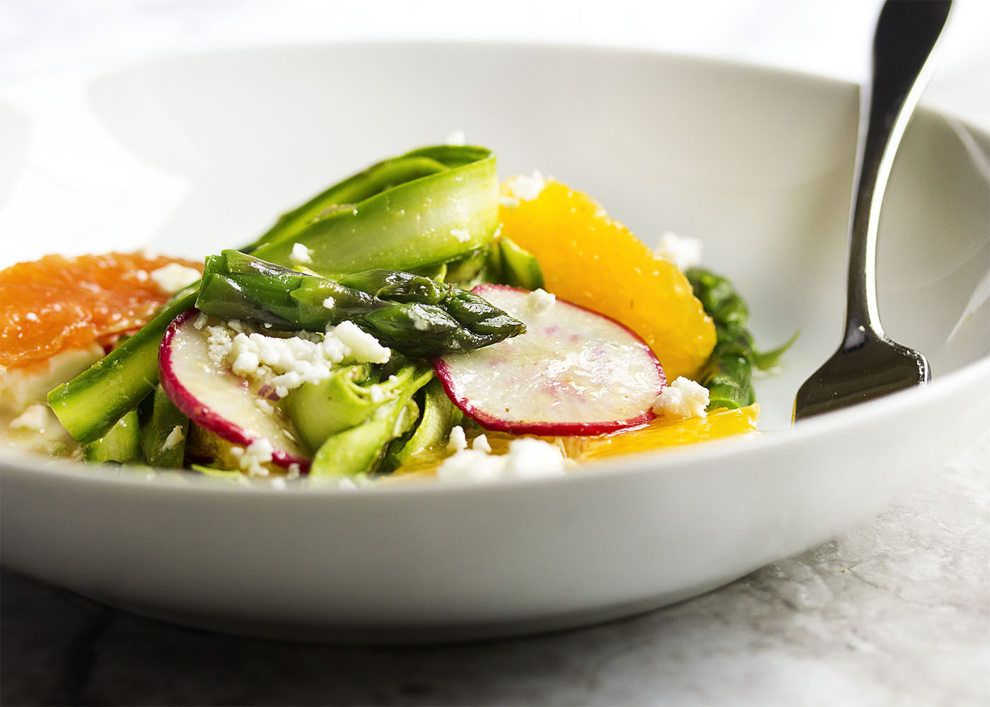 Shaved Asparagus and Orange Salad - Looking for something a little different to do with asparagus? Bored with your usual salad routine? Shaved asparagus salad is great and fun way to use asparagus with sweet oranges and spicy radishes all tossed with an orange vinaigrette. | justalittlebitofbacon.com