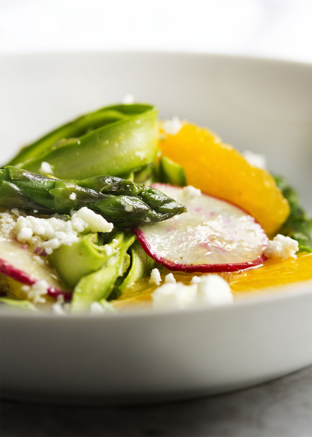 Shaved Asparagus and Orange Salad - Looking for something a little different to do with asparagus? Bored with your usual salad routine? Shaved asparagus salad is great and fun way to use asparagus with sweet oranges and spicy radishes all tossed with an orange vinaigrette. | justalittlebitofbacon.com