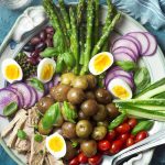 Spring Asparagus Nicoise Salad Canned tuna packed in a jar of olive oil and fresh asparagus are featured in my spring nicoise salad! Set it up on a large platter for the best presentation and enjoy all the crisp vegetables, soft boiled eggs, and creamy potatoes all drizzled with a simple lemon dressing. | justalittlebitofbacon.com #saladrecipes #frenchrecipes #springrecipes #spring #salad #frenchfood #asparagus