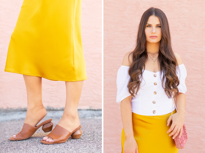LATE SUMMER 2019 LOOKBOOK | Walking on Sunshine: How to Style TopShopβs Bias Cut Satin Midi Skirt for Summer / Autumn | TopShop Yellow Satin Skirt Outfit Ideas | Casual Daytime Transitional Outfit Ideas | Brunette woman wearing a Topshop Yellow Satin Midi Skirt styled with a white button-down Bardot top, brown leather mules with a wooden heel and a Pantone Living Coral beaded bag | Summer 2019 Trends | Calgary Fashion & Creative Lifestyle Blogger // JustineCelina.com