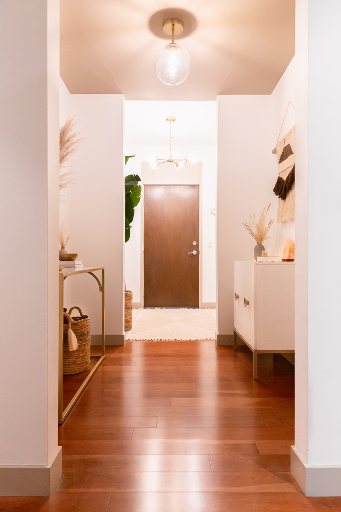 Space Refresh: Entrance Way Reveal in Partnership with Mobilia Canada | A Bohemian, Mid-Century Modern Apartment Entrance Way | Justine Celina Maguireβs Home | 2019 Home Decor Trends | Behr Ultra Pure White | Mobilia Aly Velji Modern India Collection Review | Bohemian, Mid Century Modern Decor | Faux Bird of Paradise Plant | Calgary Lifestyle, Interior Design and Home Decor Blogger // JustineCelina.com