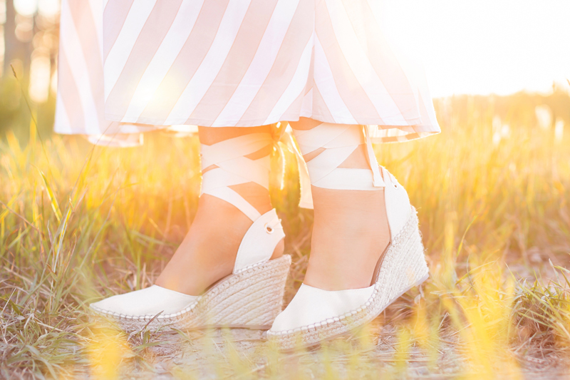 Summer 2020 Lookbook | Boho Summer 2020 Outfit Ideas | Summer Capsule Wardrobe | Summer Quarantine Outfits | Classic Summer Outfit Ideas | The Best CastaΓ±er Canvas Wedge Espadrille dupes | Summer to Fall Outfit Ideas | Classic Affordable Summer Style | Summer 2020 Trends | Best affordable wedge espadrilles | Brunette woman wearing a striped H&MDress and Cream ASOS DESIGN Time tie leg espadrille wedges in natural at sunset | Calgary Alberta Fashion Blogger // JustineCelina.com