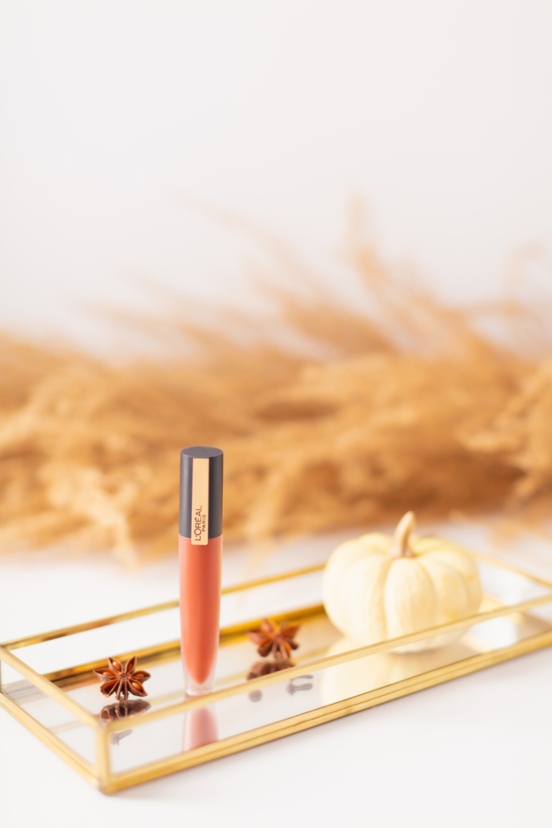 My Top 5 Pumpkin Spice Lipsticks | JustineCelinaβs favourite fall lipsticks | The Best Pumpkin Spice Lipsticks for Fall | Fall 2020 Lipstick Trends | L'Oreal Rouge Signature Liquid Lip Colour in I Amaze Photos, Review, Swatches | Light / Medium Skintone | The Best Drugstore Fall Lipsticks | The Best Pumpkin Spice Lipsticks for Fall | Lipstick on a Mirrored Tray with spices, a white mini pumpkin and pampas grass in the background | Calgary Beauty Blogger // JustineCelina.com