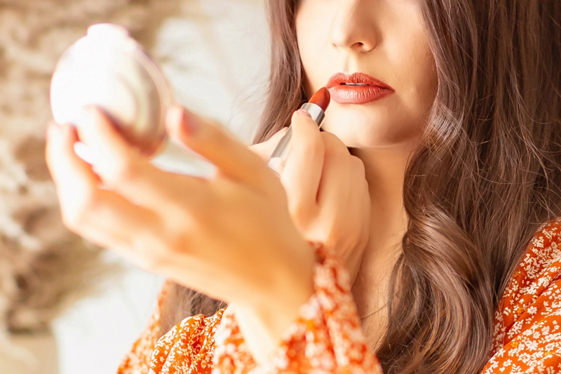 My Top 5 Pumpkin Spice Lipsticks | JustineCelinaβs favourite fall lipsticks | The Best Pumpkin Spice Lipsticks for Fall | Fall 2020 Lipstick Trends | MaybellineΒ Color Sensational Made For All Lipstick in Spice For Me Photos Review Swatches | Best Fall Lipsticks for a Light / Medium Skintone | The Best Drugstore Fall Lipsticks | The Best Pumpkin Spice Lipsticks for Fall | Brunette woman wearing an orange floral dress holding a lipstick | Calgary Beauty Blogger // JustineCelina.com