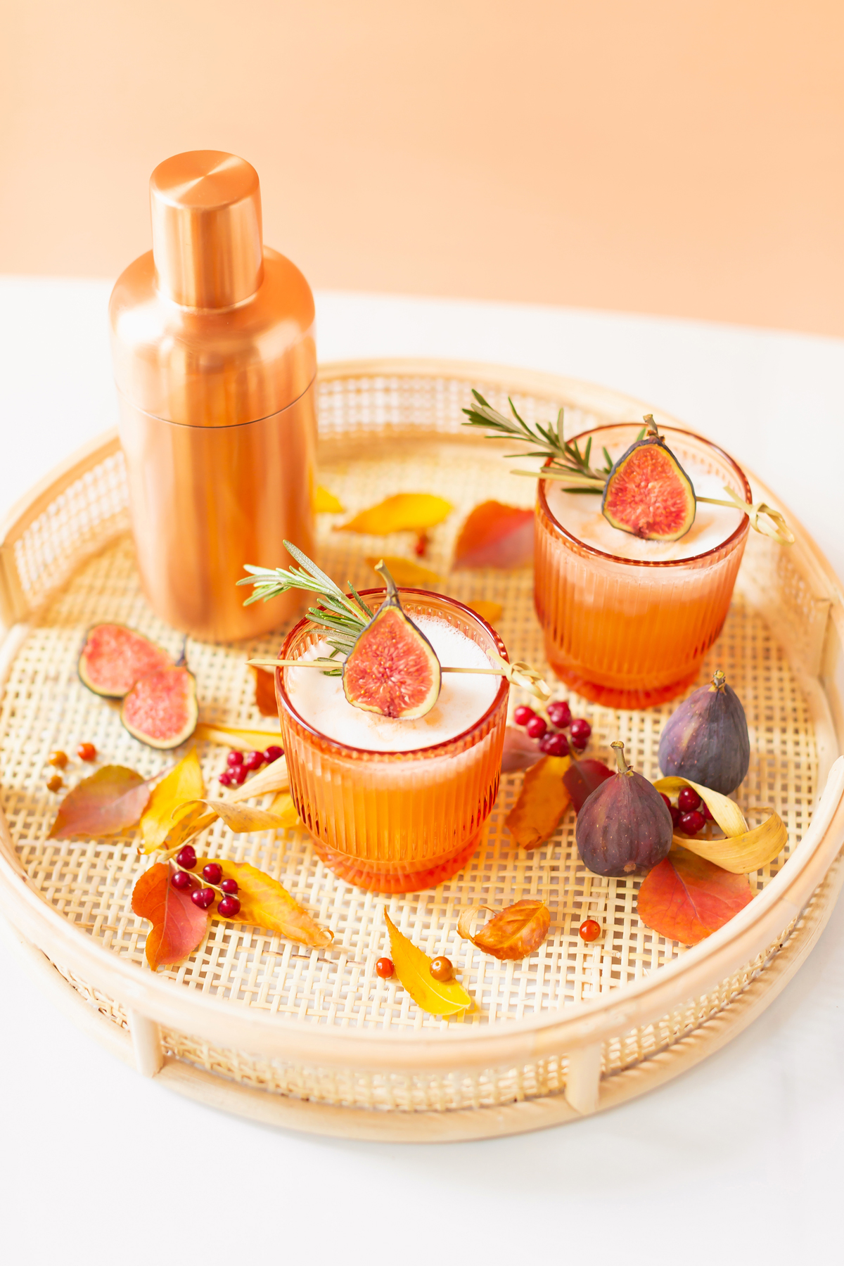 5 Cozy Fall Cocktail and Sangria Recipes | JustineCelinaβs Best Fall Cocktail and Sangria Recipes | Rosemary Fig Japanese Whisky Sour | A Whisky Sour Cocktail with a Fresh Fig Garnish on a Rattan Serving Tray with Autumn Leaves and a Brass Cocktail Shaker in the Background | Autumn Whiskey Cocktails | Best Fall Whisky Cocktail Recipes | Fall Fig Cocktail | Japanese Whisky Cocktail | Nikka Super Rare Old Cocktail | Calgary Cocktail Photographer and Stylist | Calgary Blogger // JustineCelina.com