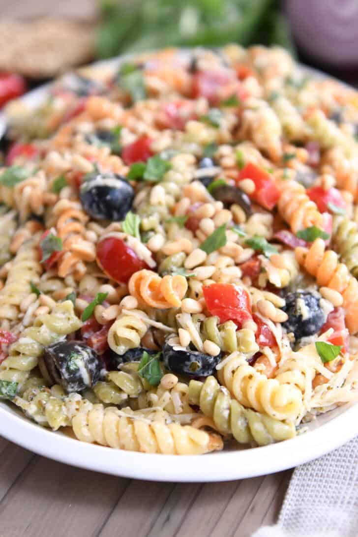 Tri-color pasta salad on white platter.