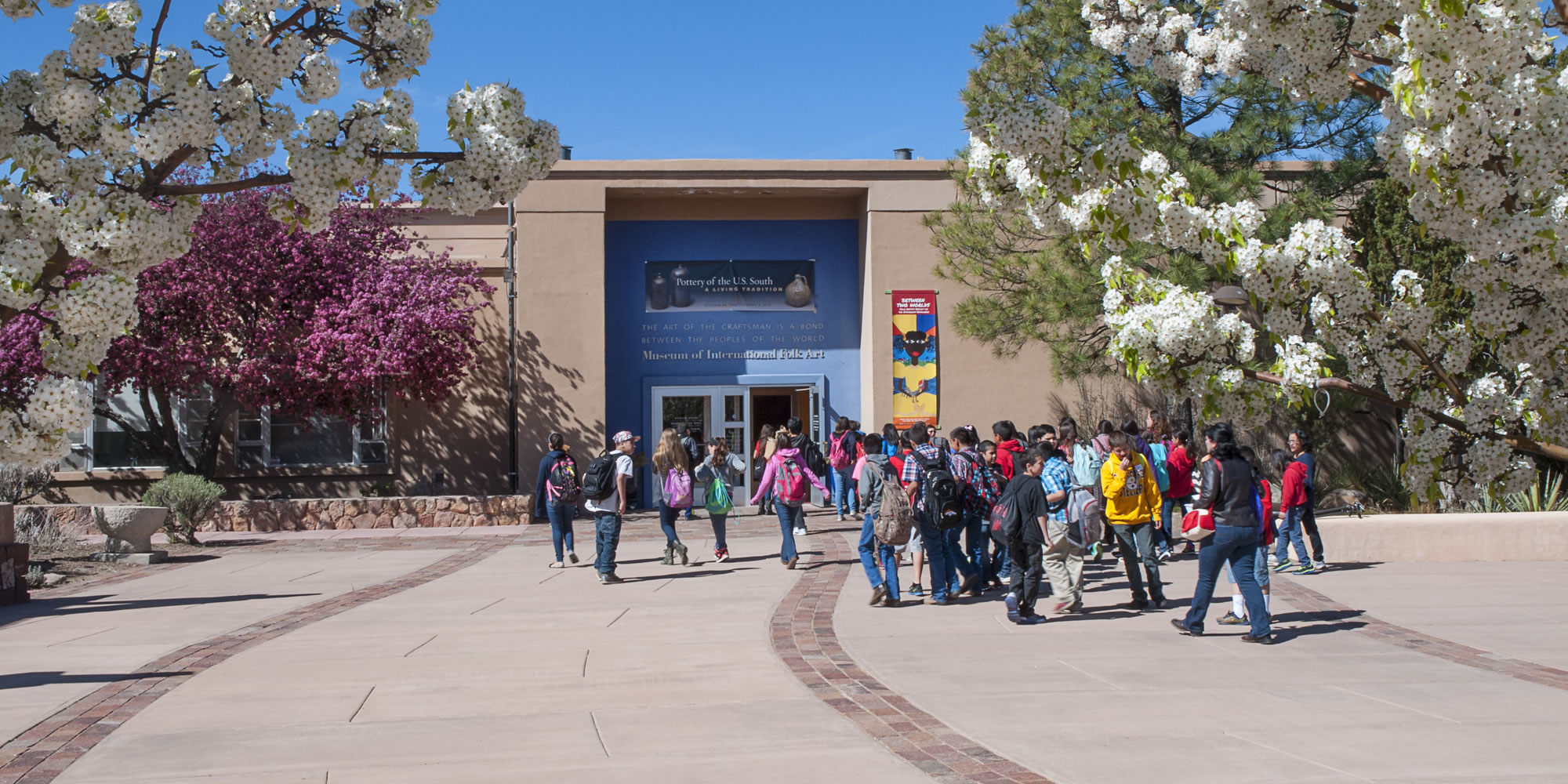 Students approach the front entrance of the Museum of International Folk Art|.