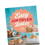 The cover of the book Easy Air Fryer Bakes by Lucy Parissi, featuring colorful cakes, cookies, and desserts displayed on stands against a blue background.