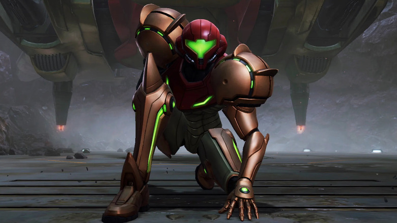 Samus Aran kneels on one knee in front of her spaceship in 
