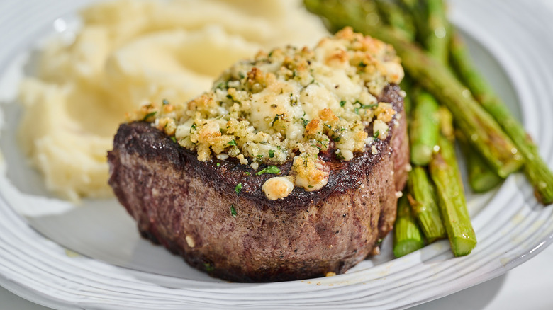 Blue cheese crusted filet mignon steak on a plate