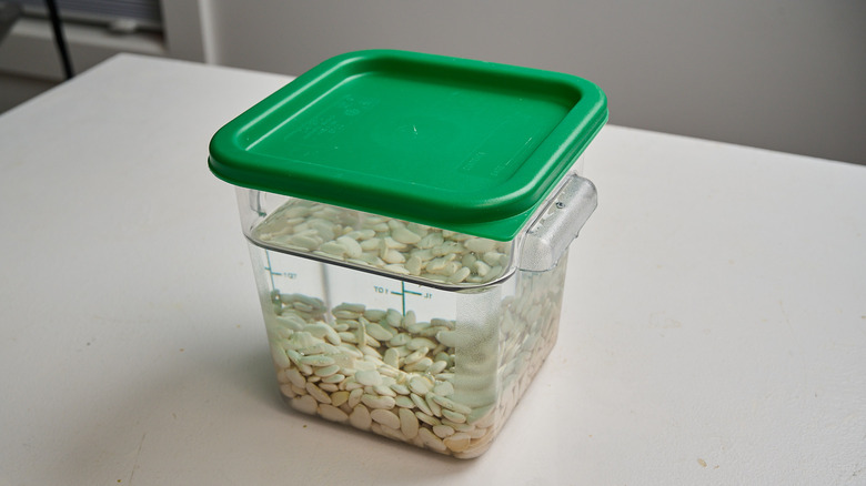 soaking beans in a container of water