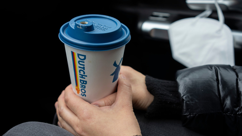 hand holding Dutch Bros cup