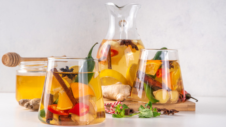 Fire cider glass with herbal elements