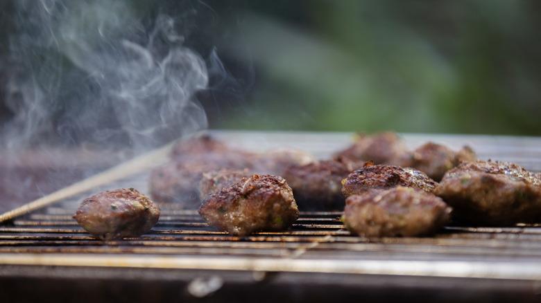 Meatballs cooking on a grill