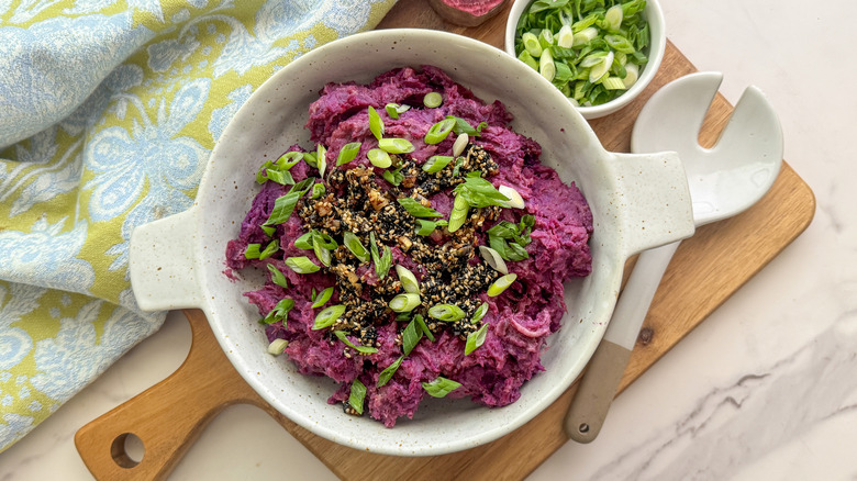 Purple mashed sweet potatoes with sesame and green onion topping