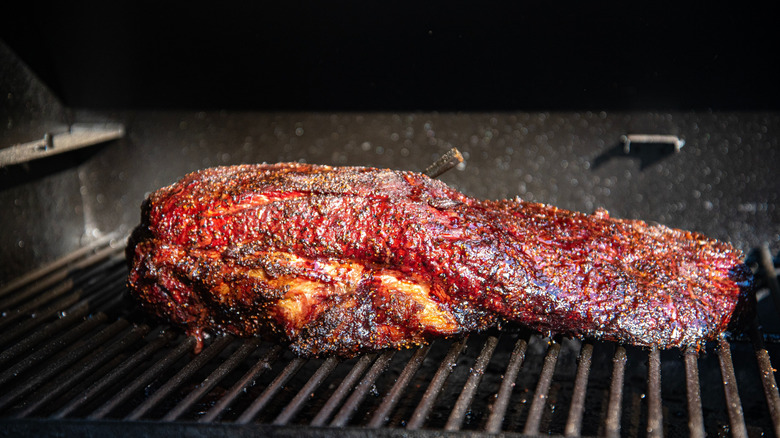 well-cooked slab of brisket on a grill