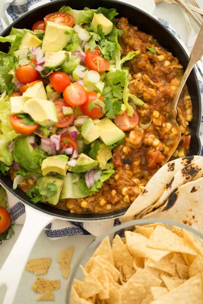 Taco Skillet recipe skillet filled with ground turkey and refried beans